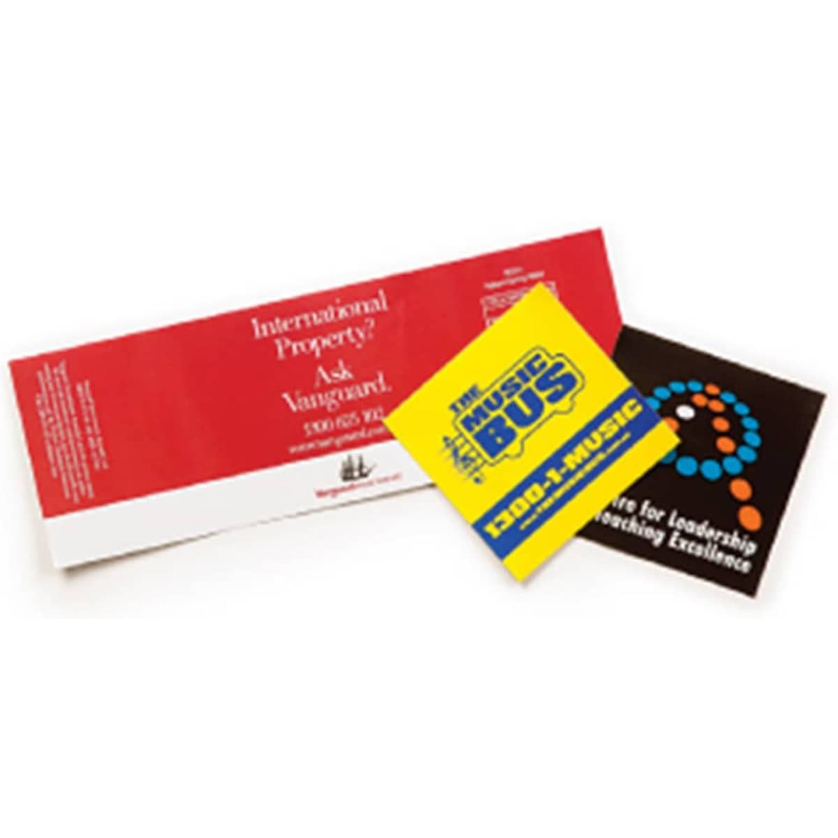 A set of three vinyl stickers in red, yellow, and black, featuring various designs and a logo.