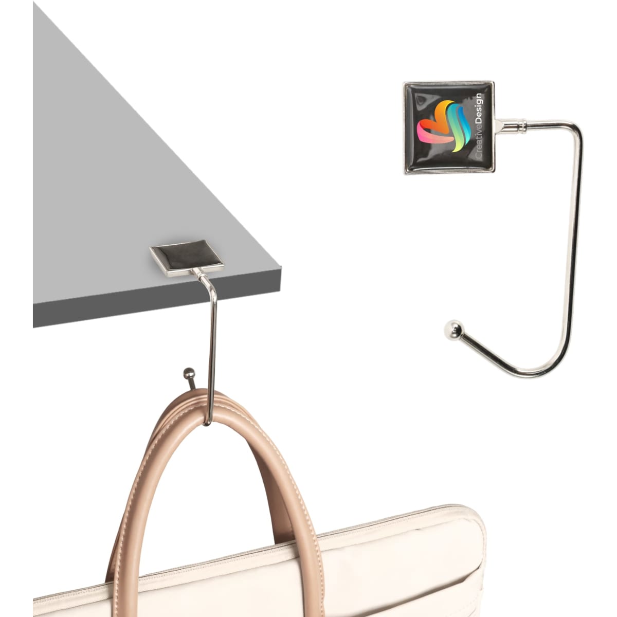 A square silver desk hook with a curved arm holding a handbag, set against a light background. It includes a logo.