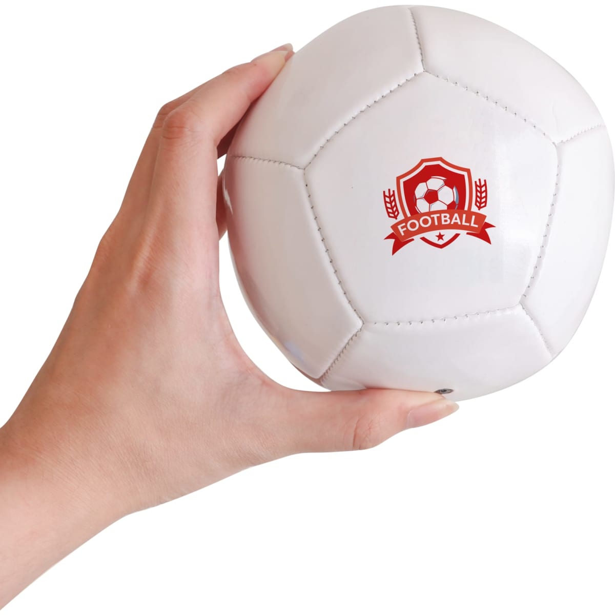 A mini white soccer ball held in a hand, featuring a logo on one side.