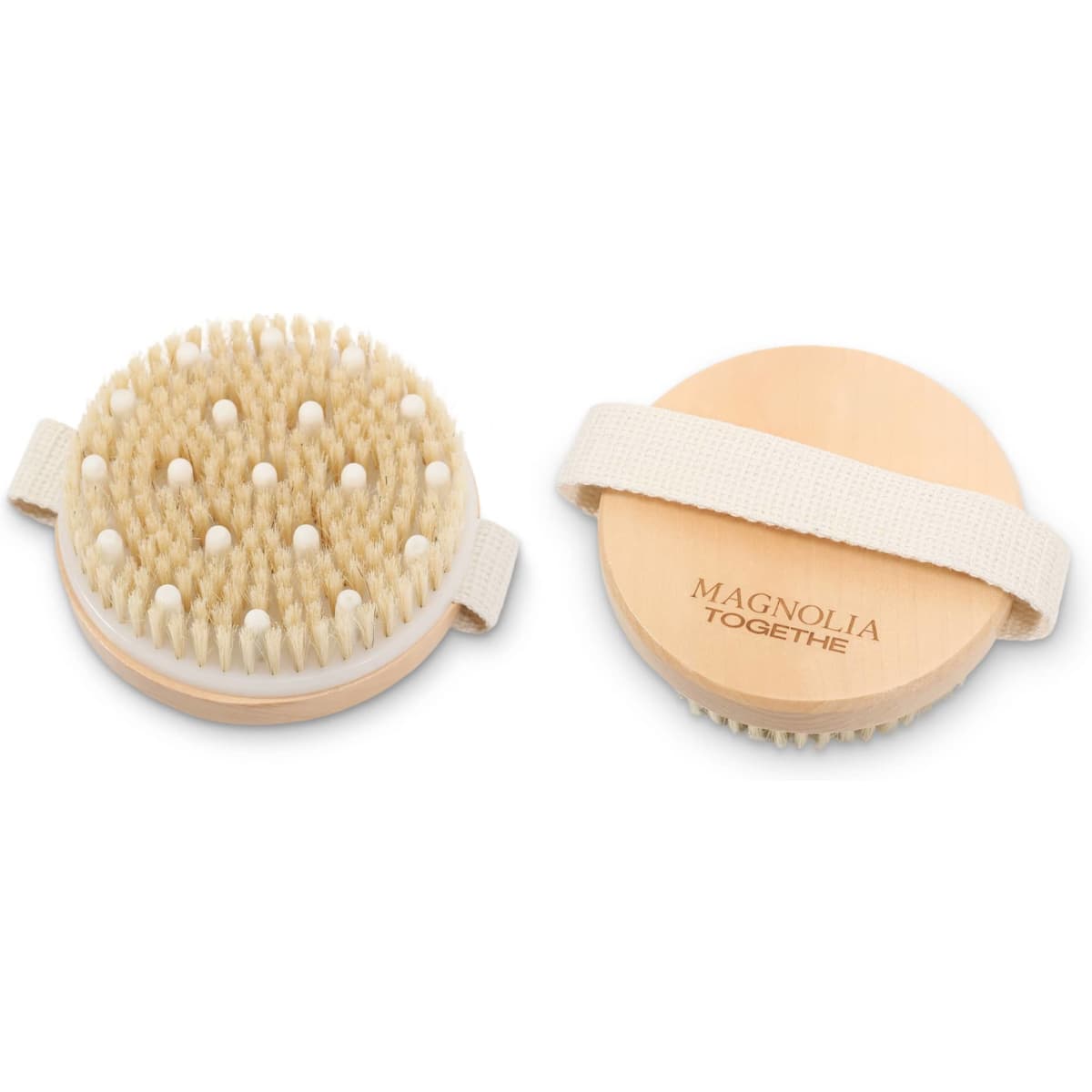 An exfoliating brush with soft massage nodules, featuring a natural wooden base and a fabric strap.