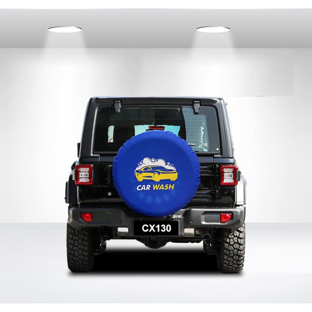A blue spare tyre cover with a logo is fitted on the back of a black vehicle, featuring a textured surface.