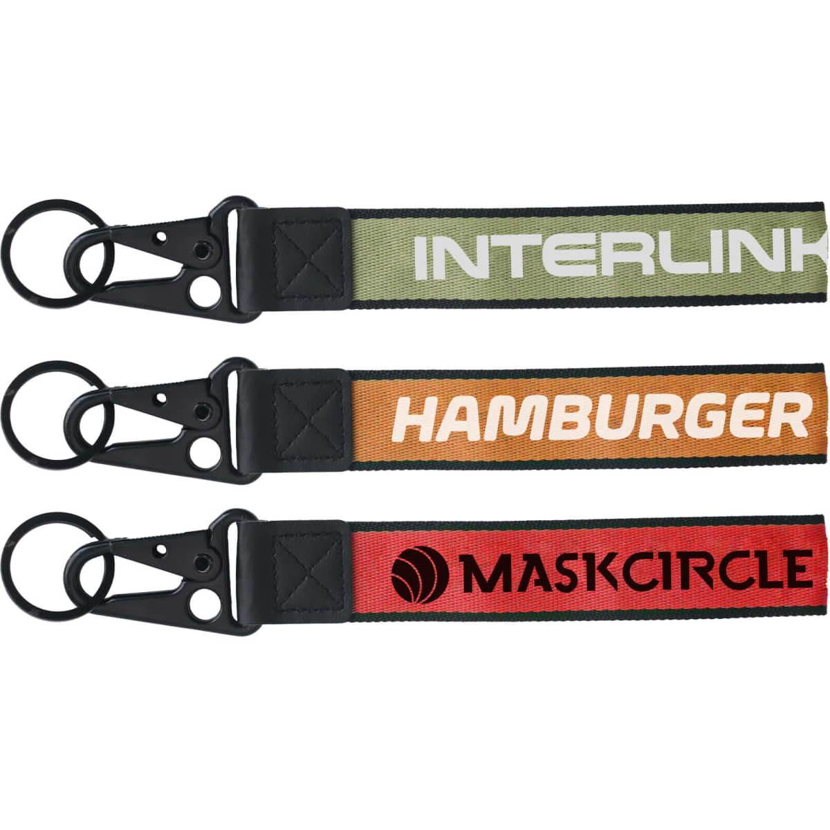 Three keyrings in green, orange, and red, featuring various designs and attached metal clasps. Each has a logo.