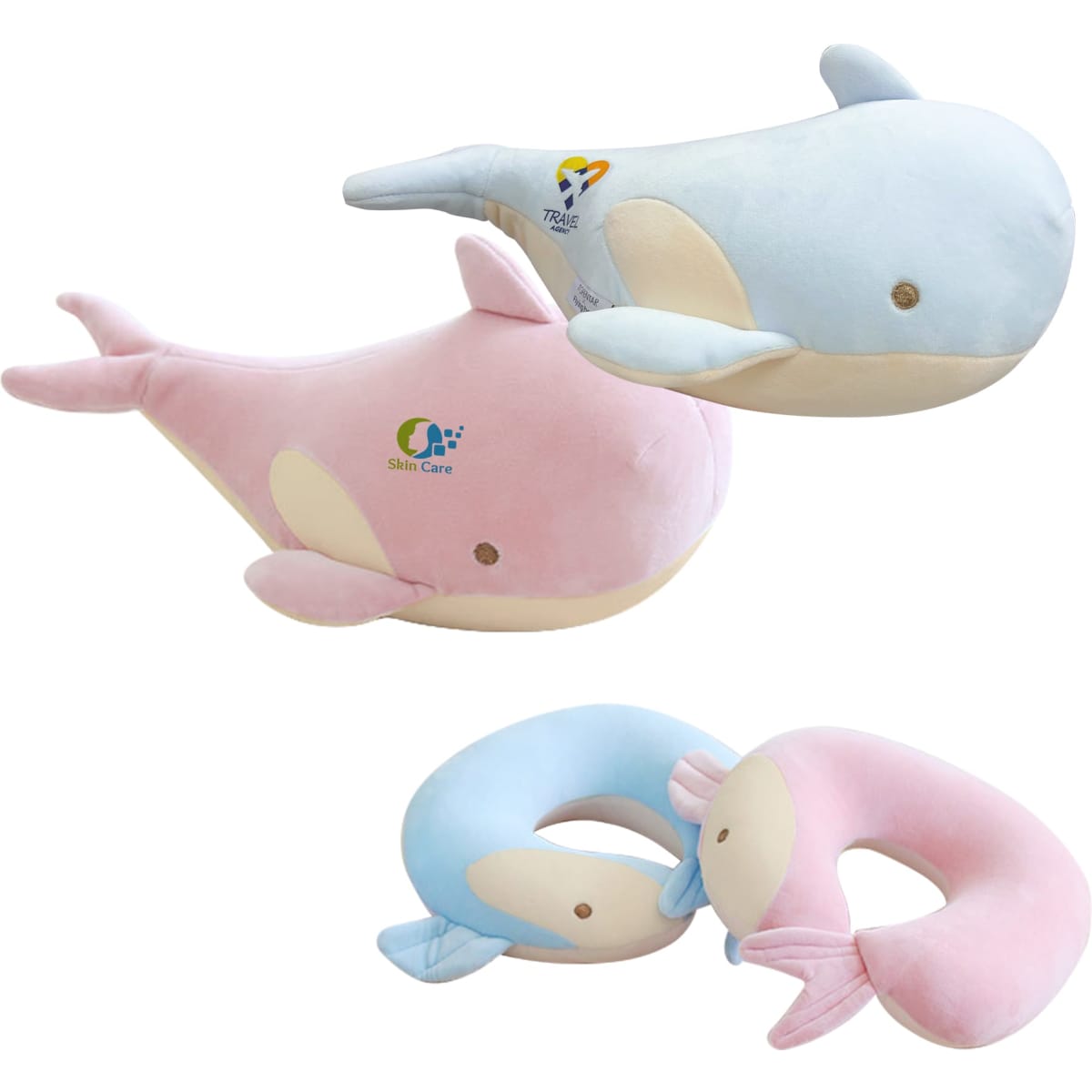 A plush travel pillow shaped like a whale, featuring pink and light blue colours, with a logo on the side.