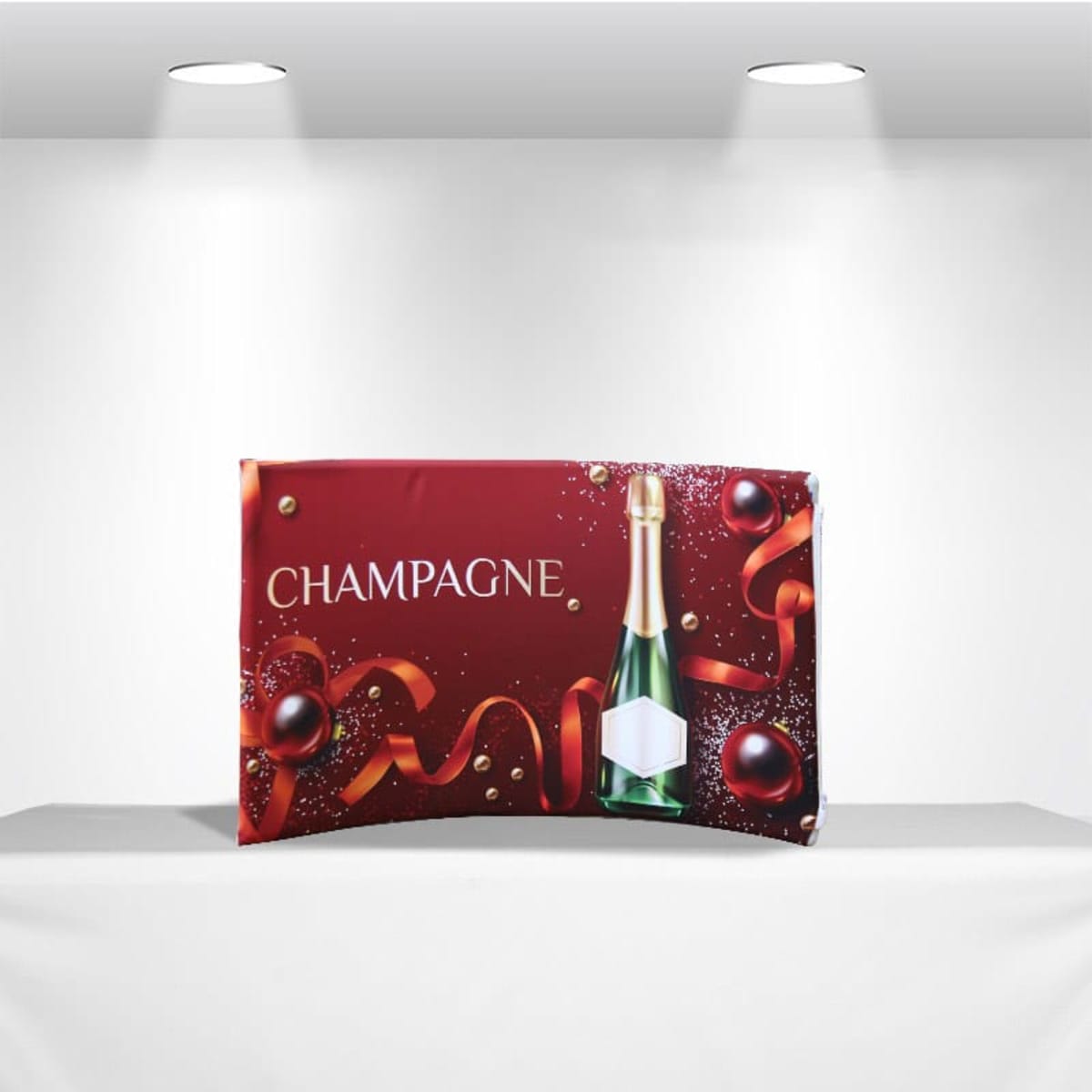 A vibrant red tabletop tension fabric display featuring a champagne bottle and decorative elements. It includes a logo.