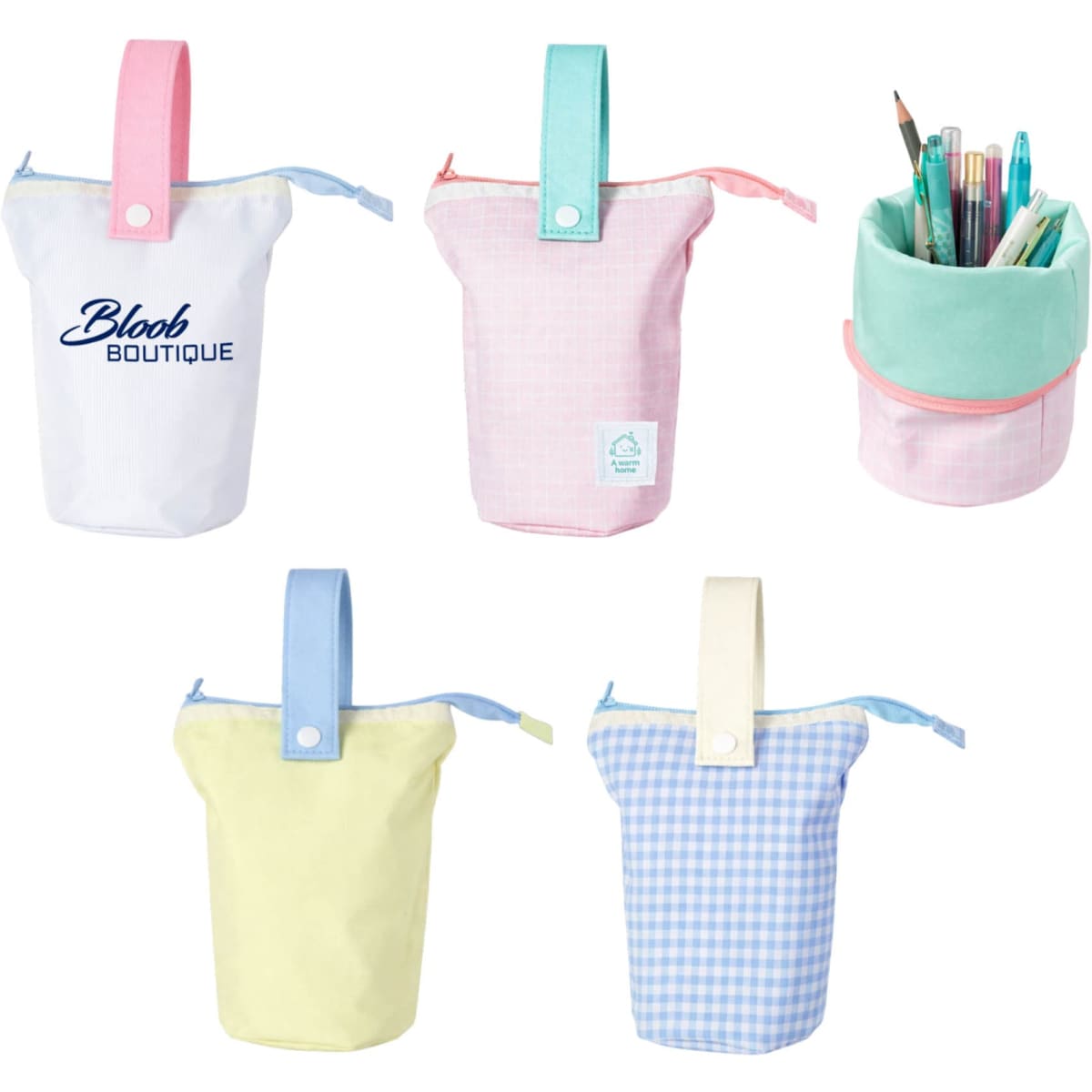A foldable pencil case with handle in pastel colours: pink, yellow, and mint, featuring a logo.