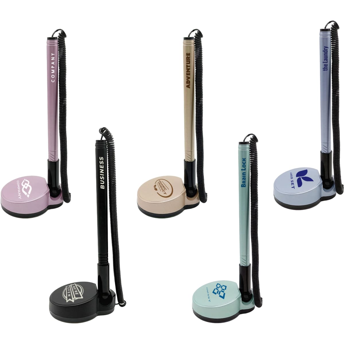 A set of five fixed signature pens on stands, featuring pastel colours like pink, beige, and blue, with various branding.