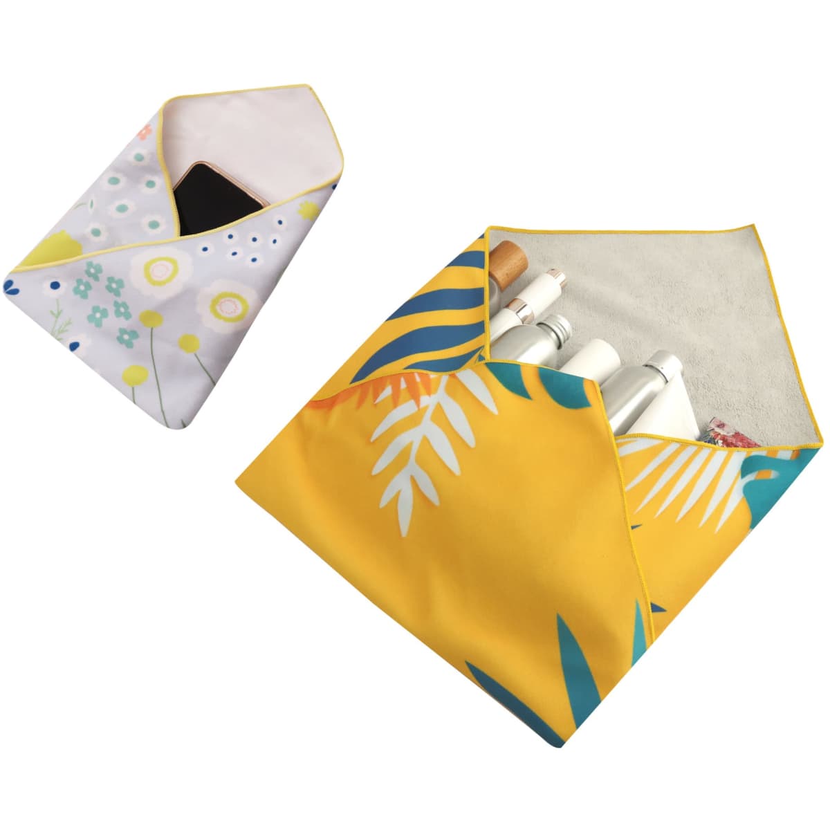 Two vibrant self-adhesive cloth pouches in floral and tropical leaf designs, one with a phone and the other with cosmetics.