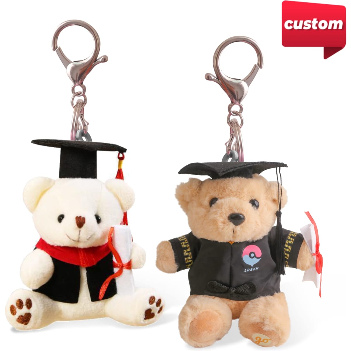 Two plush bear keyrings are dressed in graduation caps and gowns, featuring a tan bear and a cream bear, each with a clip.