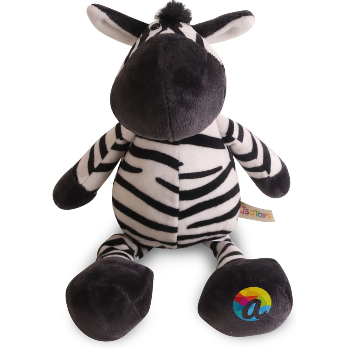 A plush zebra toy in black and white stripes with a soft, rounded body and a colourful logo on its foot.