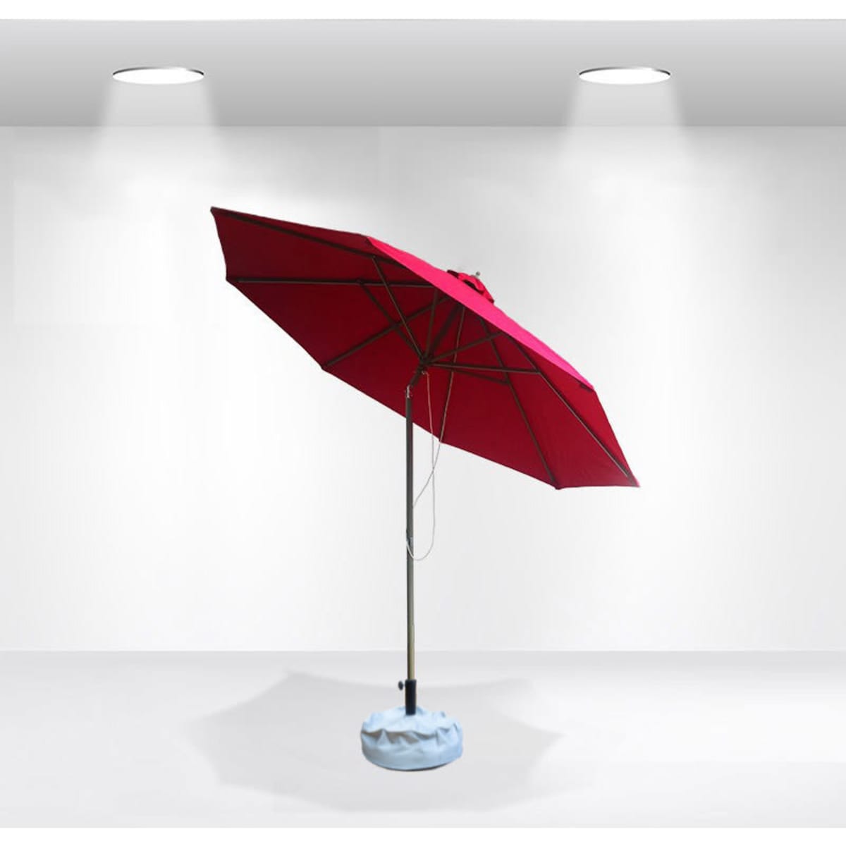 A red tilting patio umbrella with a light blue base, designed for outdoor use. It features a metal pole and canopy.