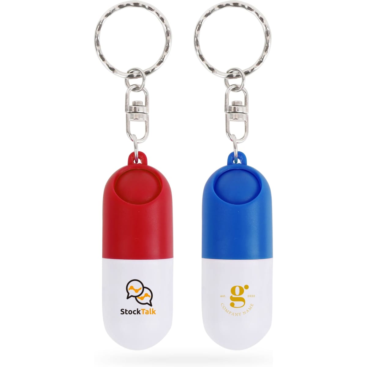 A red and white pill capsule keychain alongside a blue and white pill capsule keychain, both with logos.