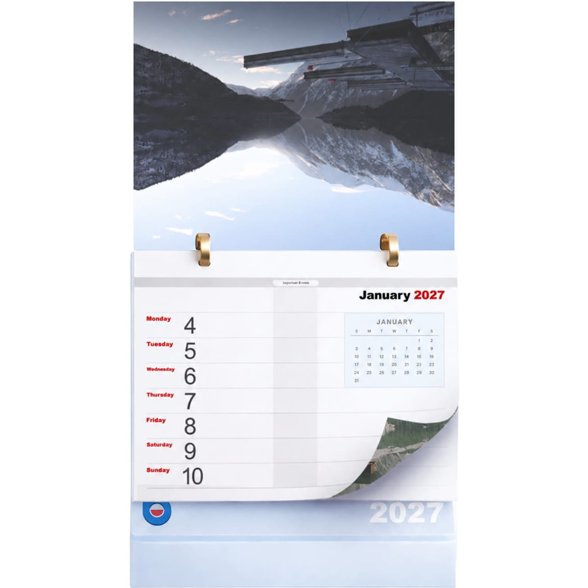 A desk calendar featuring a mountain landscape, with January 2027 pages and a gold ring binding at the top.