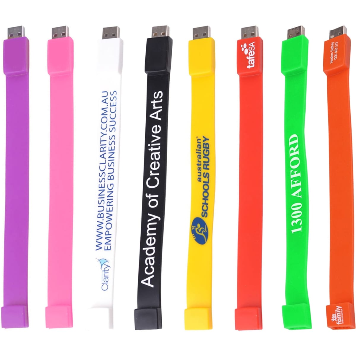 A variety of rectangular silicone wristband flash drives in colours including pink, white, yellow, green, orange, and purple, each with logos.