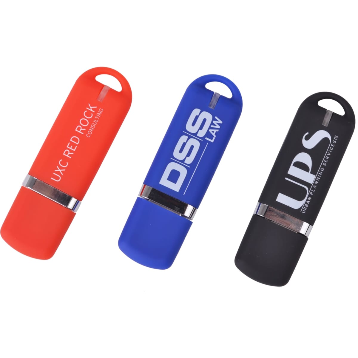 Three flash drives in red, blue, and black colours, each featuring a logo and a cylindrical design.