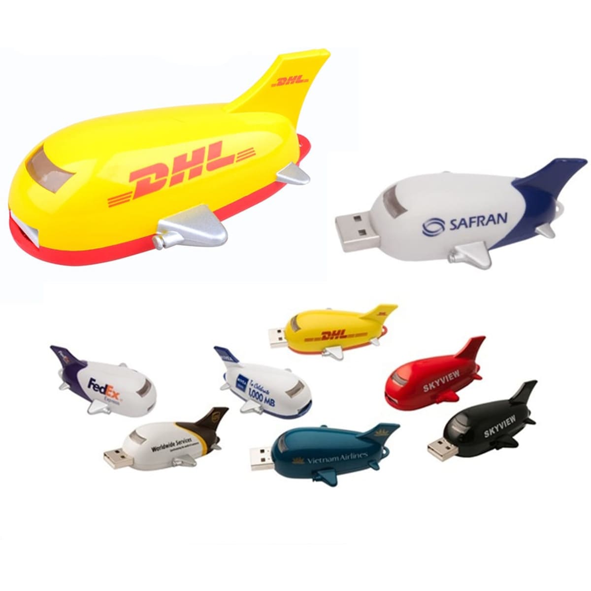 A set of colourful aircraft-shaped flash drives in yellow, white, and black, featuring various brand logos.