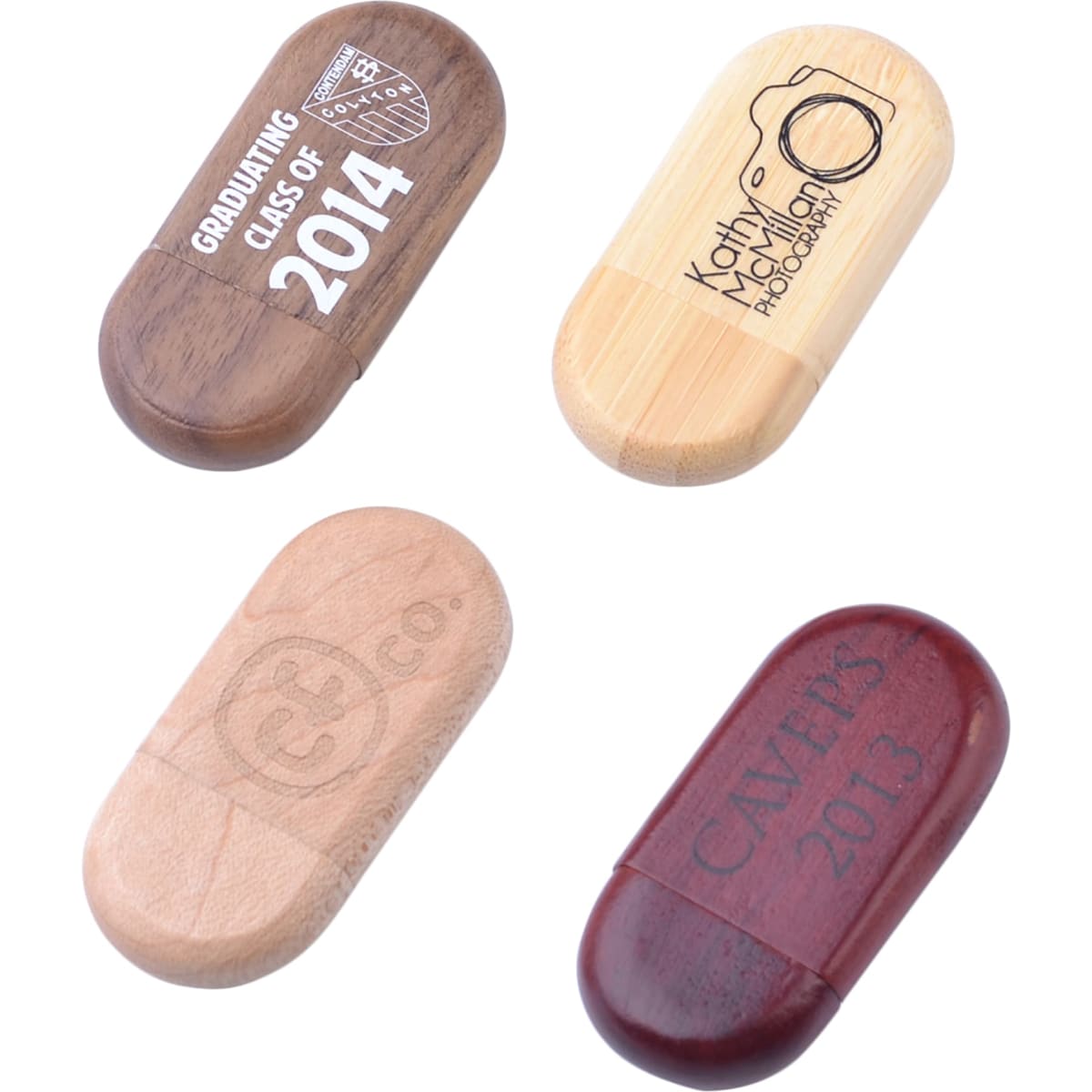 An assortment of oblong wooden flash drives in various finishes, featuring different engravings and a logo.