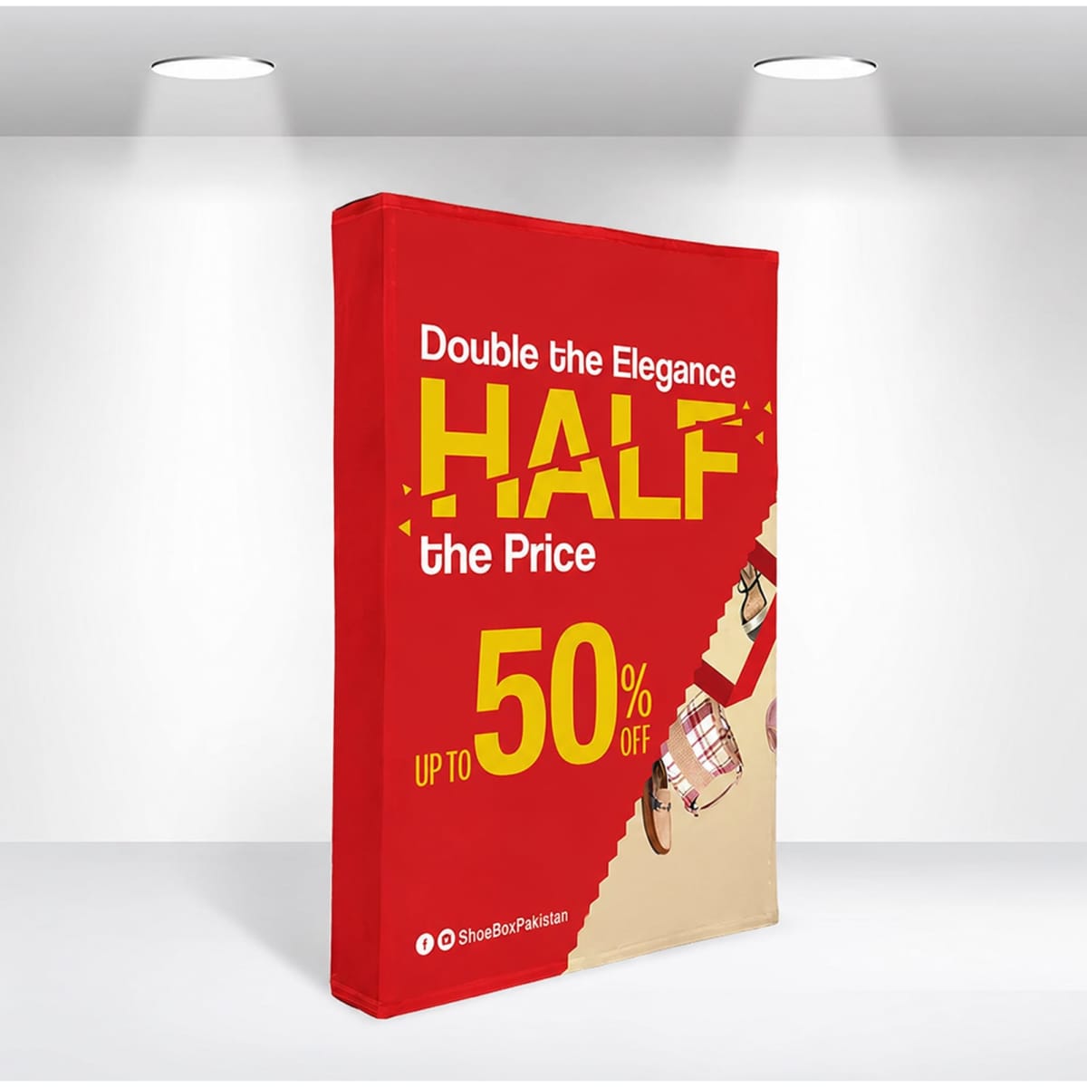 A red fabric popup display with a promotional design featuring a logo, showcasing a sale message and product images.