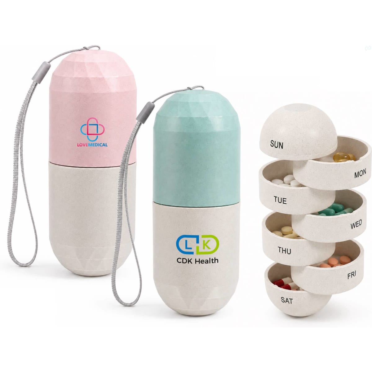 A capsule-shaped pills organiser in pink and mint green, with a logo and a detachable strap for convenience.