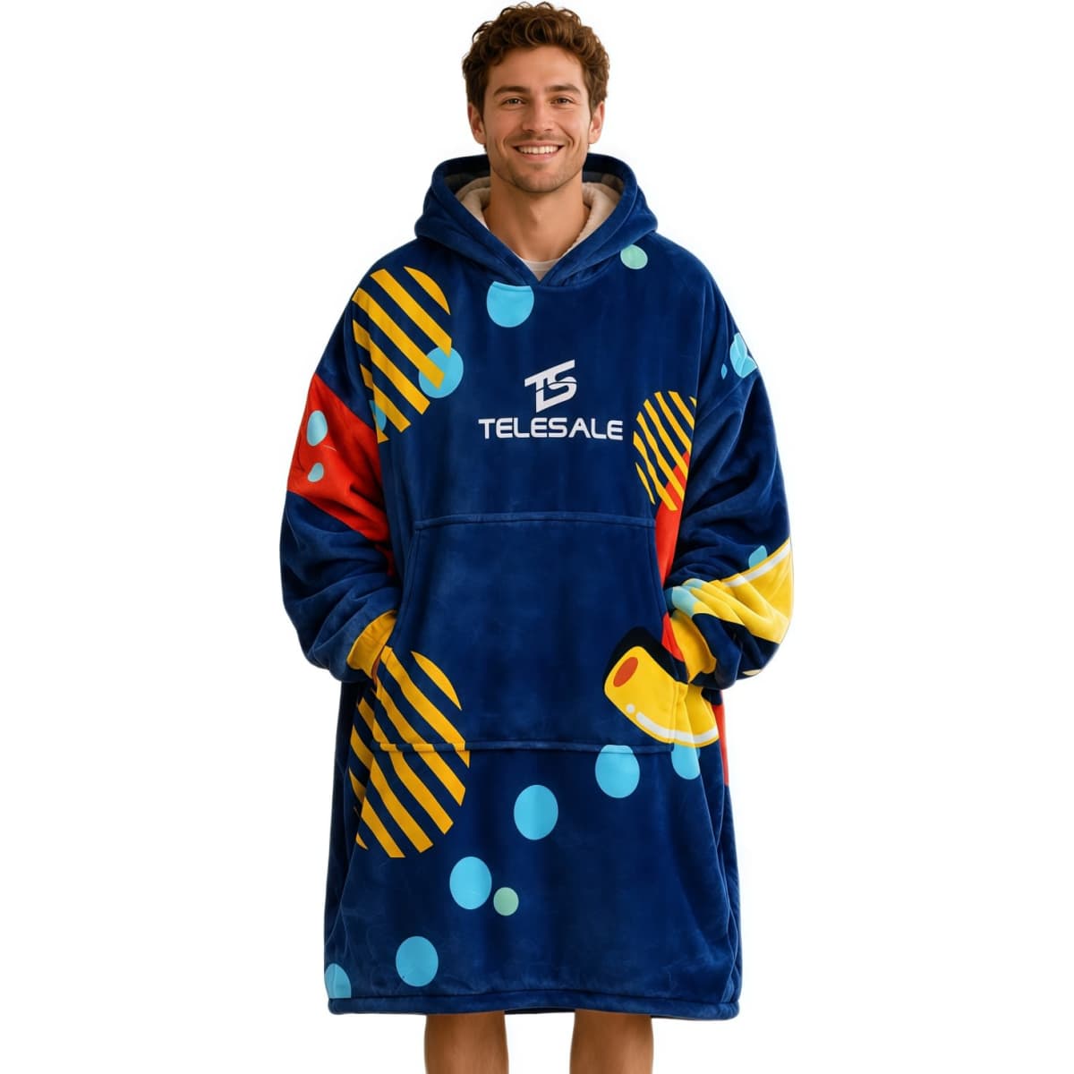 A vibrant blue wearable blanket featuring multicoloured patterns and a hood, made from 100% polyester with an absorbent lining.