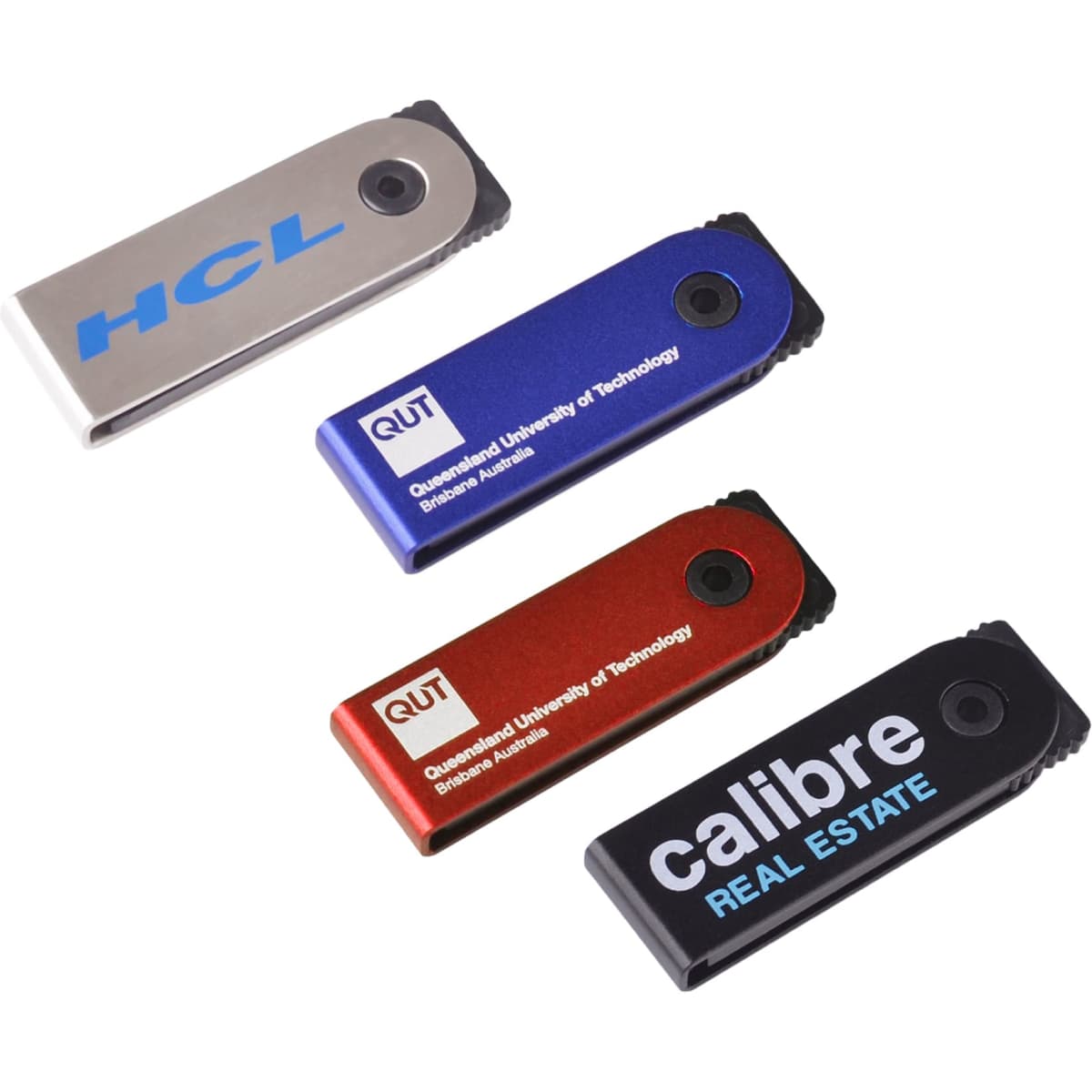 A group of four mini flash drives in silver, blue, red, and black colours, each featuring a logo or branding.