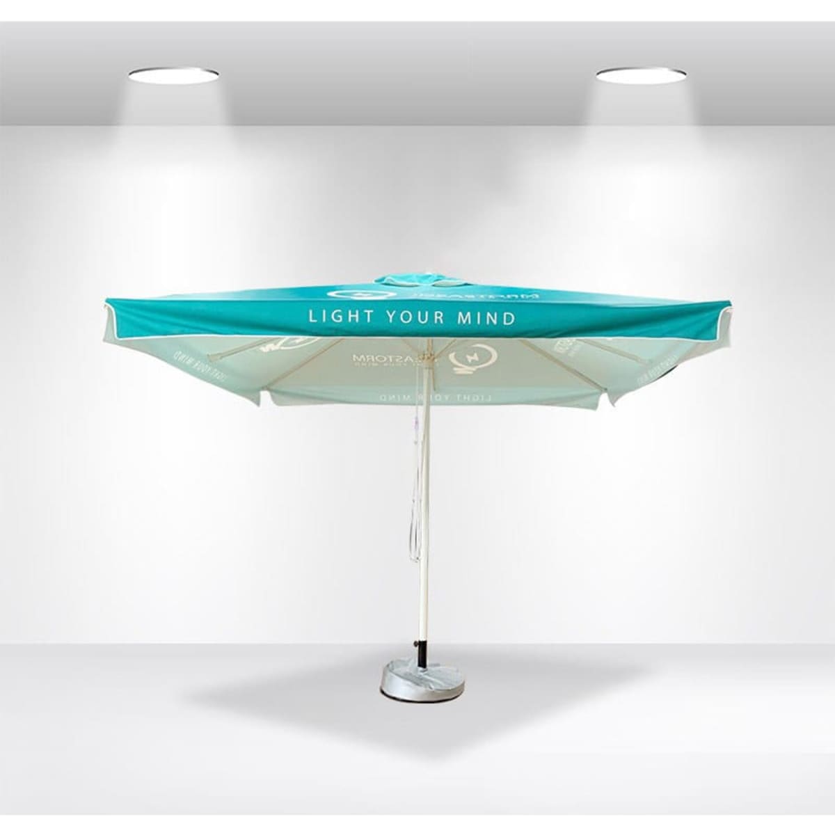 A green and white market umbrella with valances, featuring a central pole and a sturdy base.
