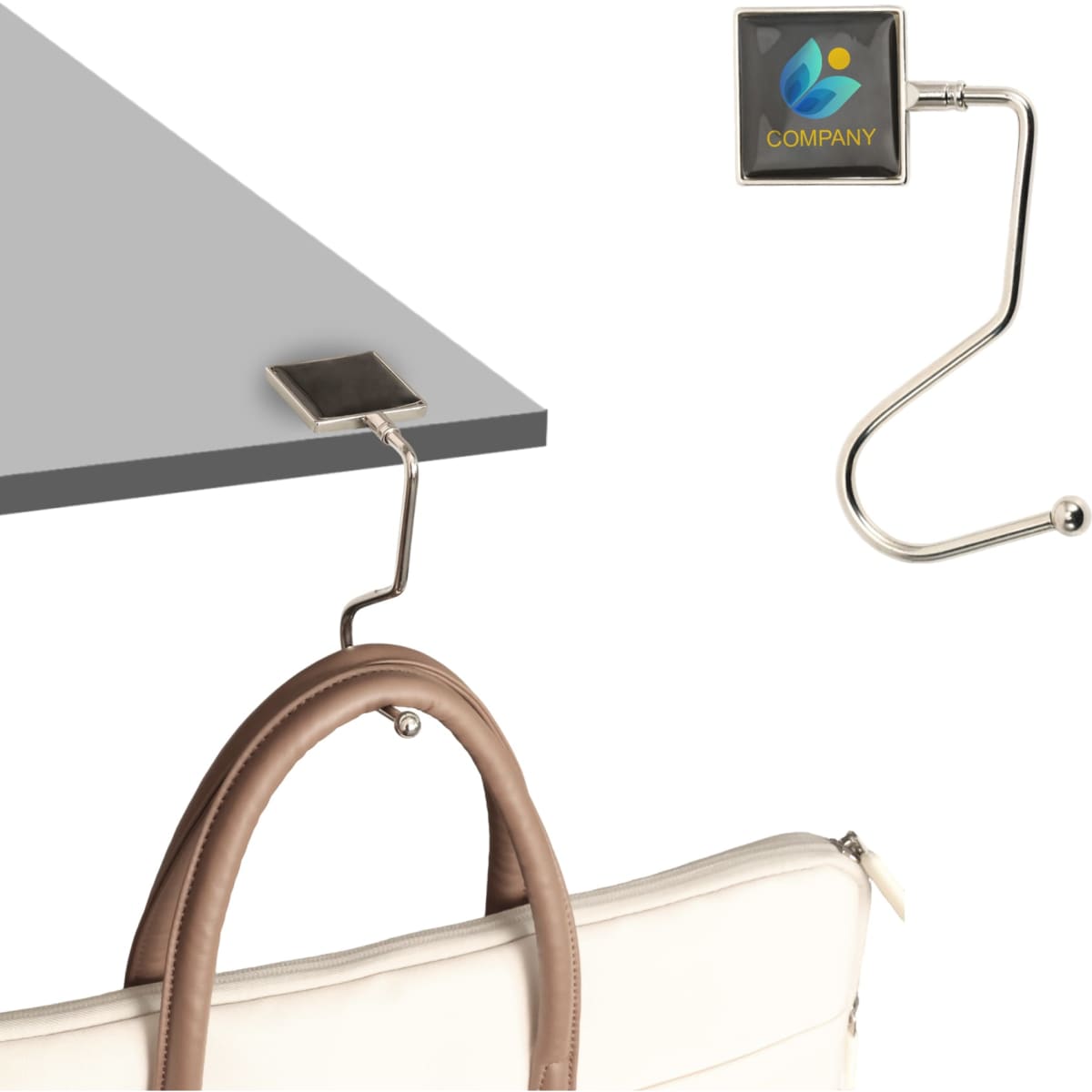 A silver curved desk hook features a square attachment with a logo, designed to hold bags or items.