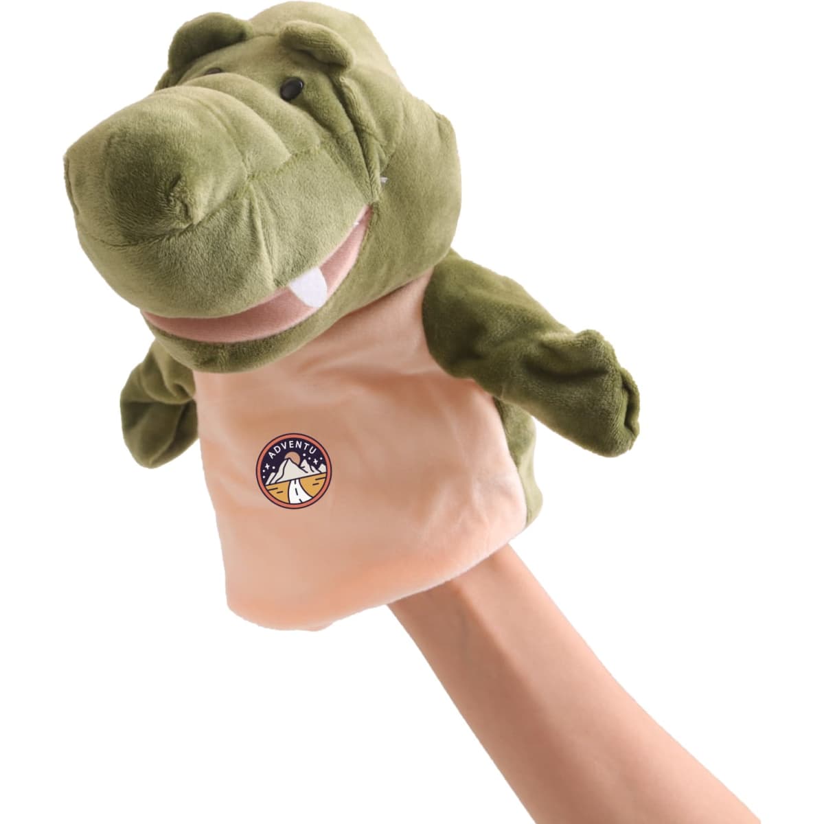 A green crocodile hand puppet with a beige body and embroidered logo, held up by a hand.
