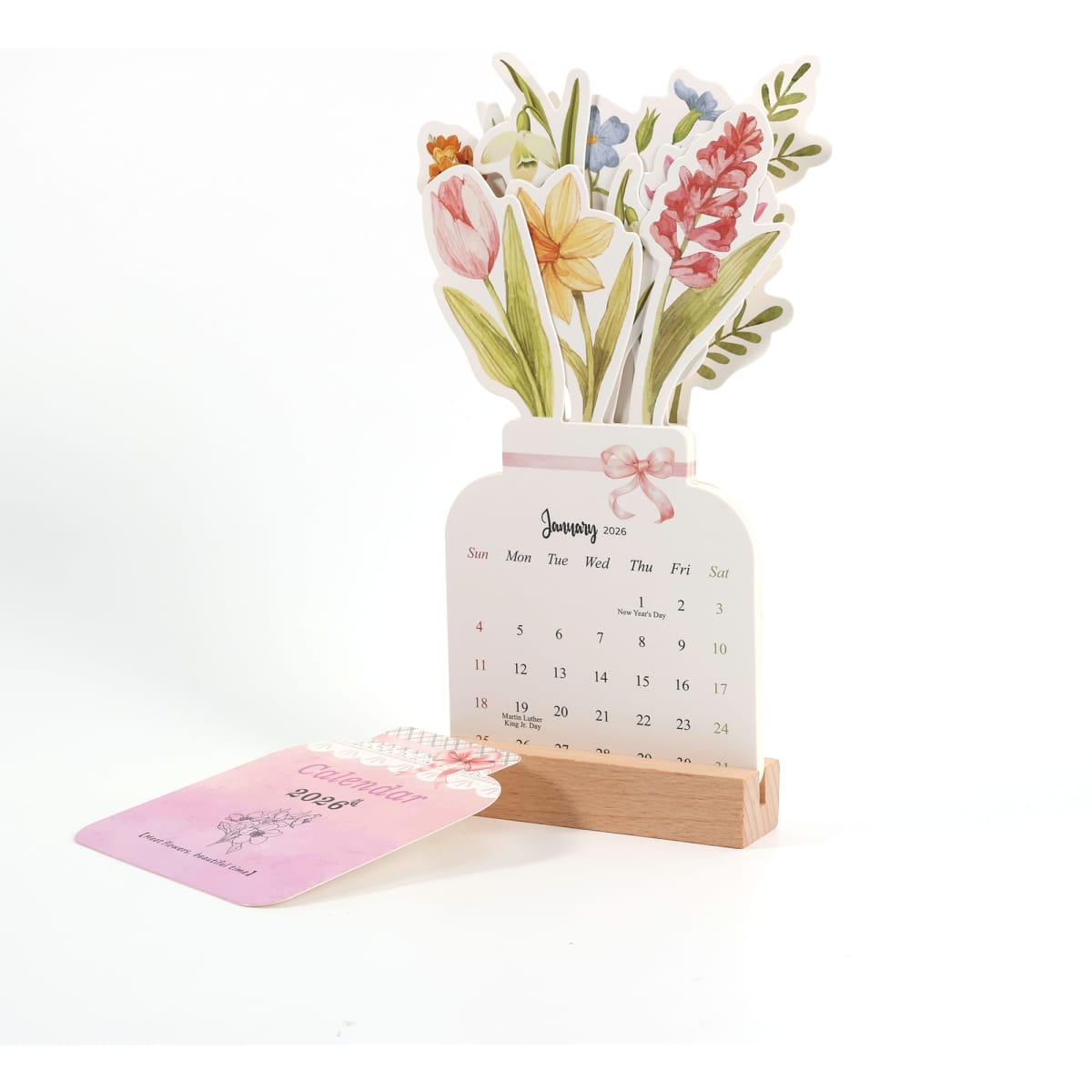 A desk calendar featuring a floral design with pink and yellow flowers, set in a wooden holder.