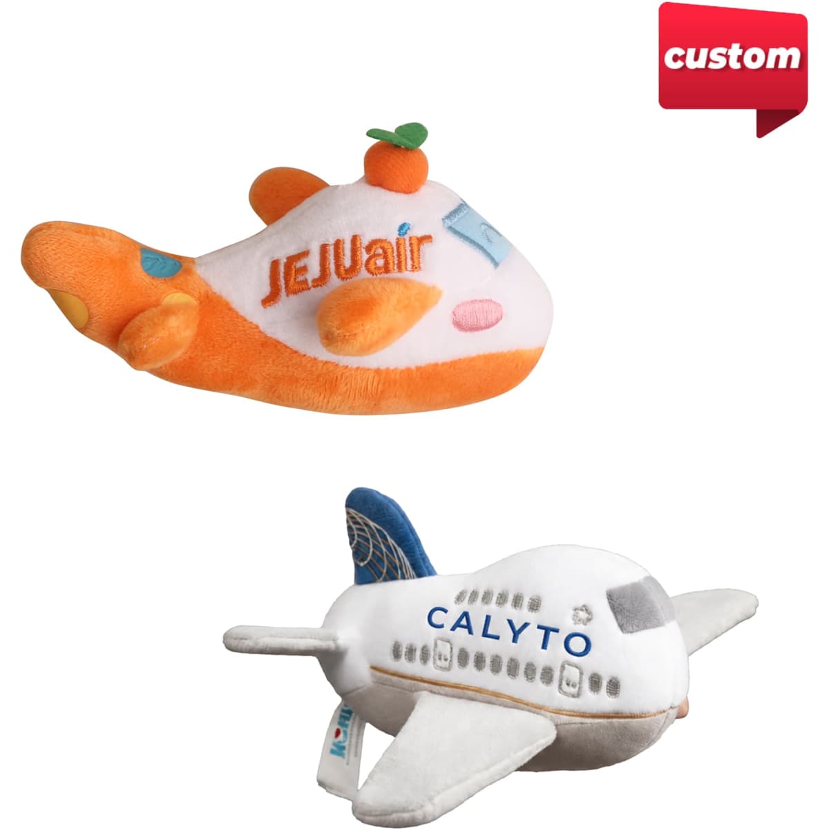 Two custom plush airplane toys, one in orange and white with a citrus accent, the other in white and blue, featuring different designs.