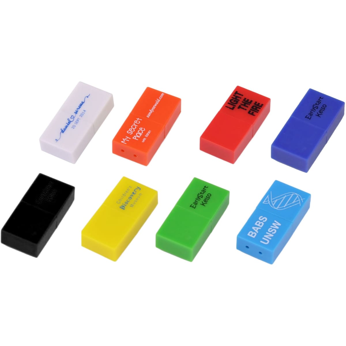 A collection of colourful brick-shaped flash drives in various shades: red, blue, green, yellow, black, and white.