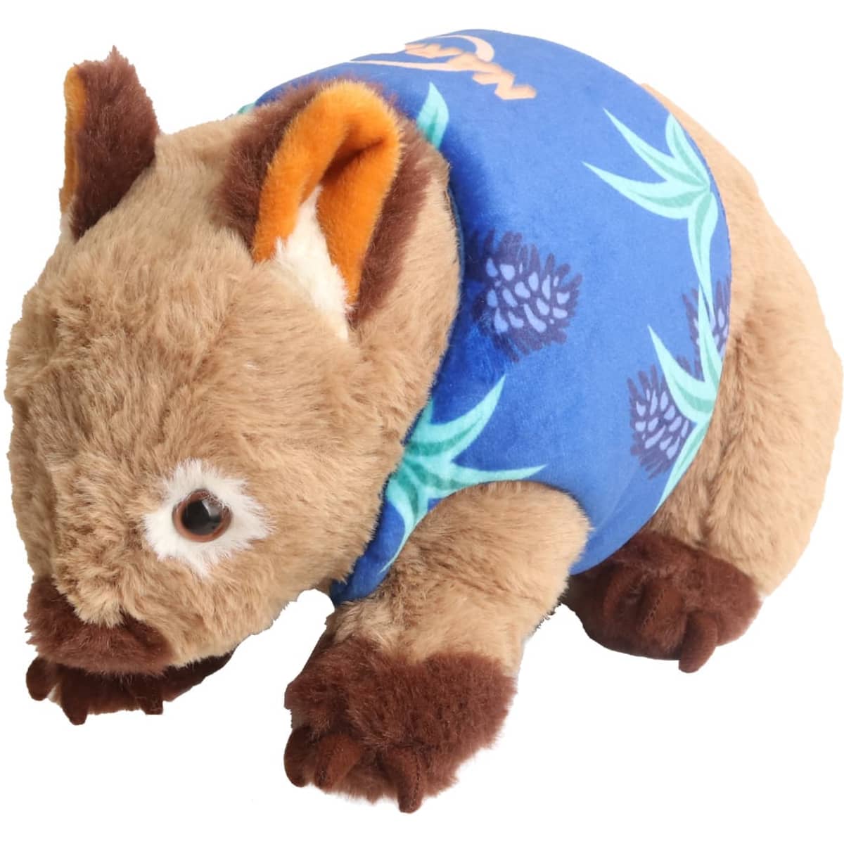 A plush wombat toy in brown with a blue patterned shirt featuring leaves and pineapples.