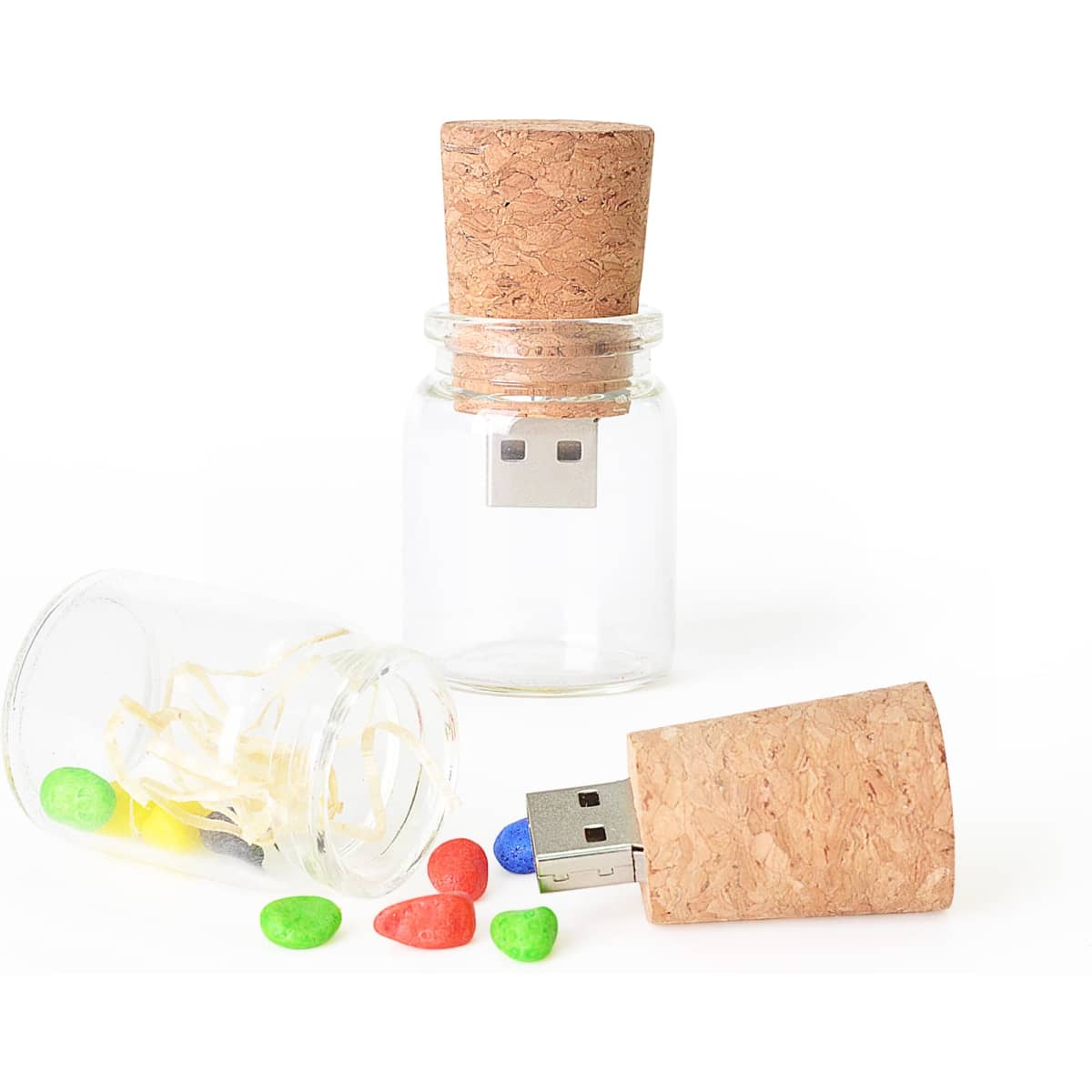 A drink bottle-shaped flash drive with a cork lid, accompanied by a glass bottle containing colourful candies.