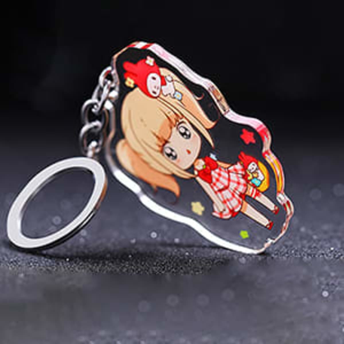 A custom-shaped acrylic keytag featuring a character in a red and white outfit with a keyring attachment.