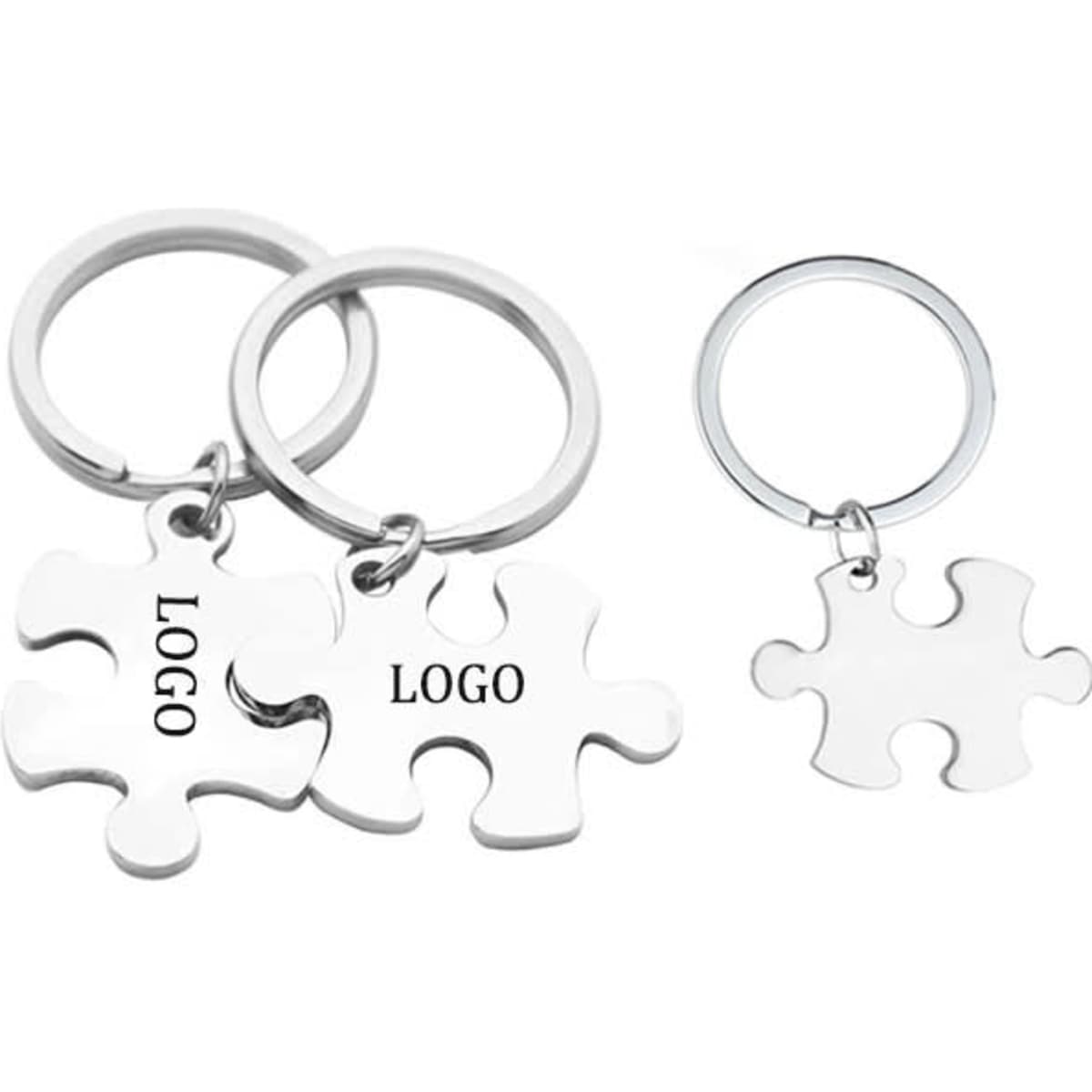 Stainless steel keychains shaped like puzzle pieces, featuring a logo, in silver colour.