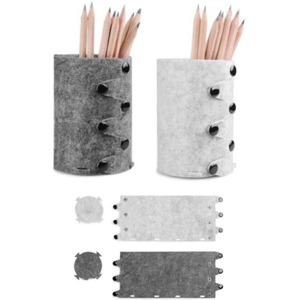 Foldable wool felt pen container in grey and white, with pencils arranged inside and additional components laid flat.