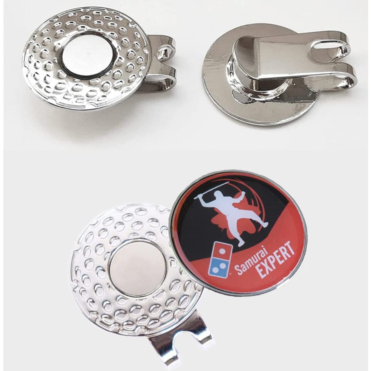 A silver magnetic ball marker hat clip with a textured surface and a circular attachment. Features a logo on the marker.