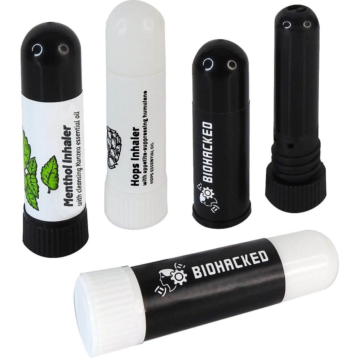 Aromatherapy inhalers in black, white, and a patterned design, featuring different tops and a logo on one.