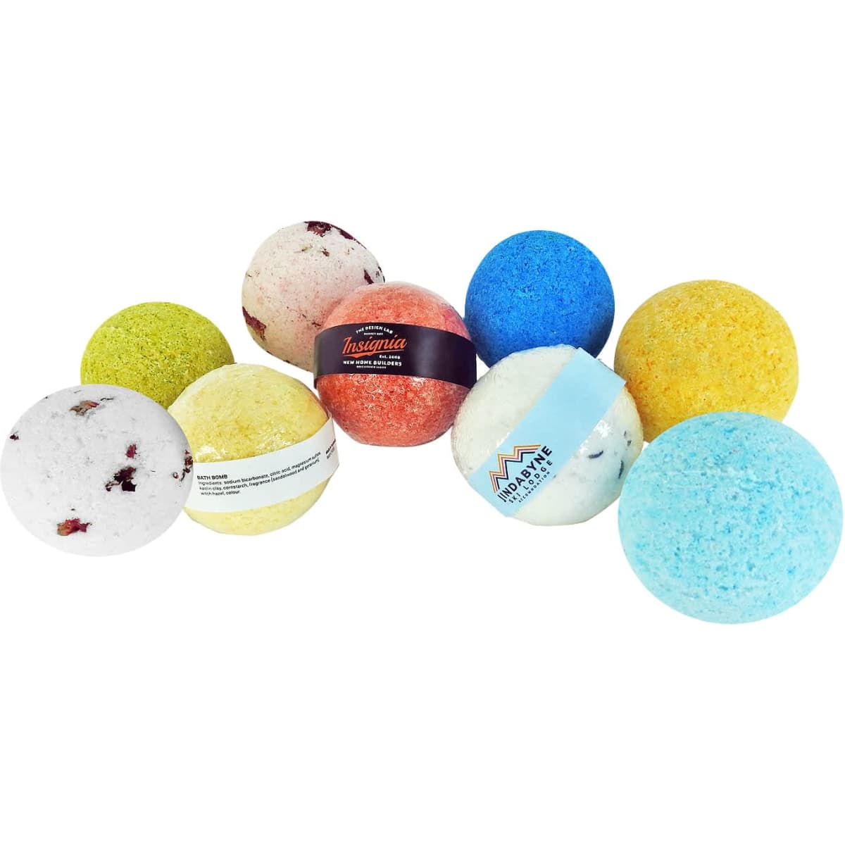 A collection of bath bombs in various colours, including blue, green, yellow, orange, and white, with assorted textures.