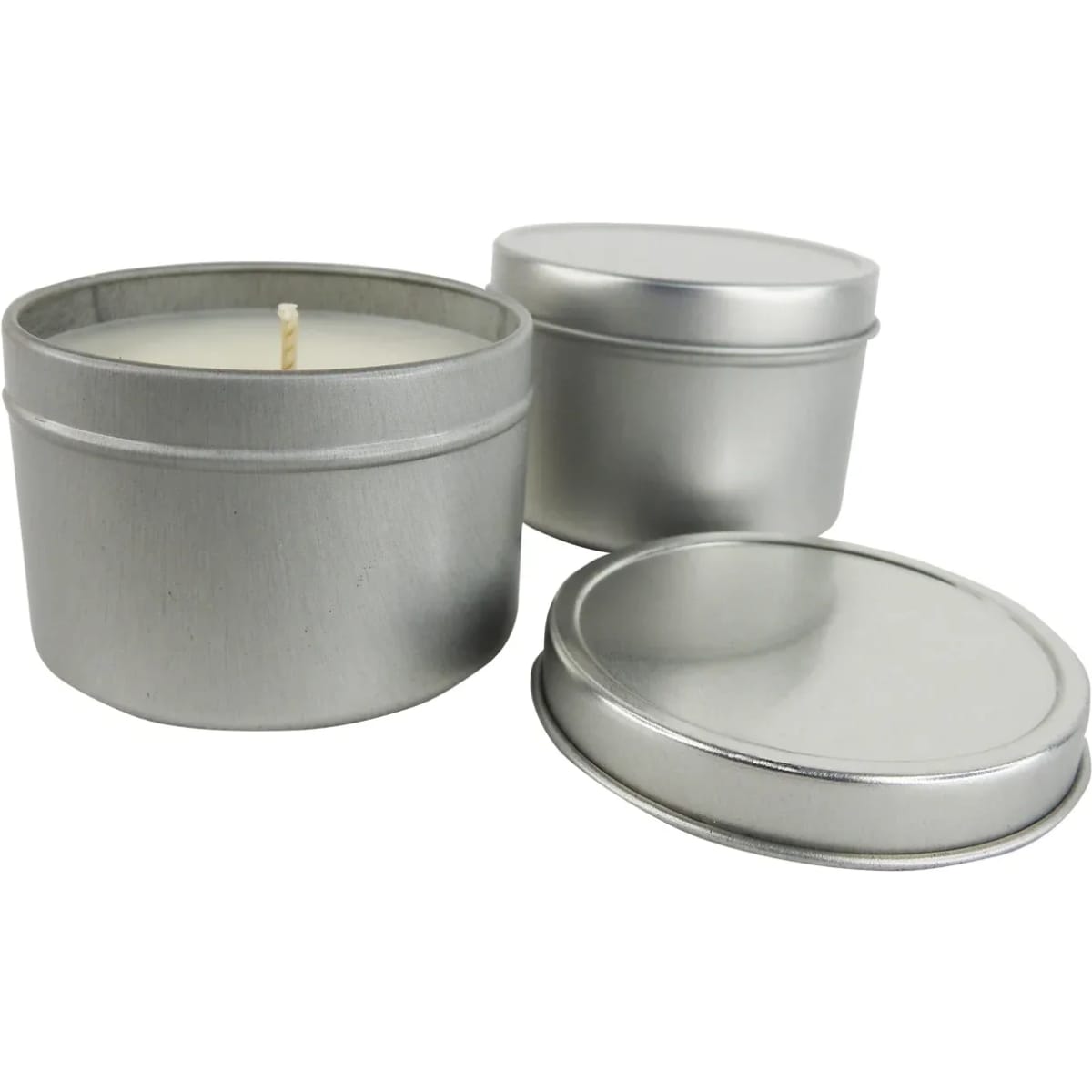 A set of large silver candle tins, one filled with a candle and the others with lids.