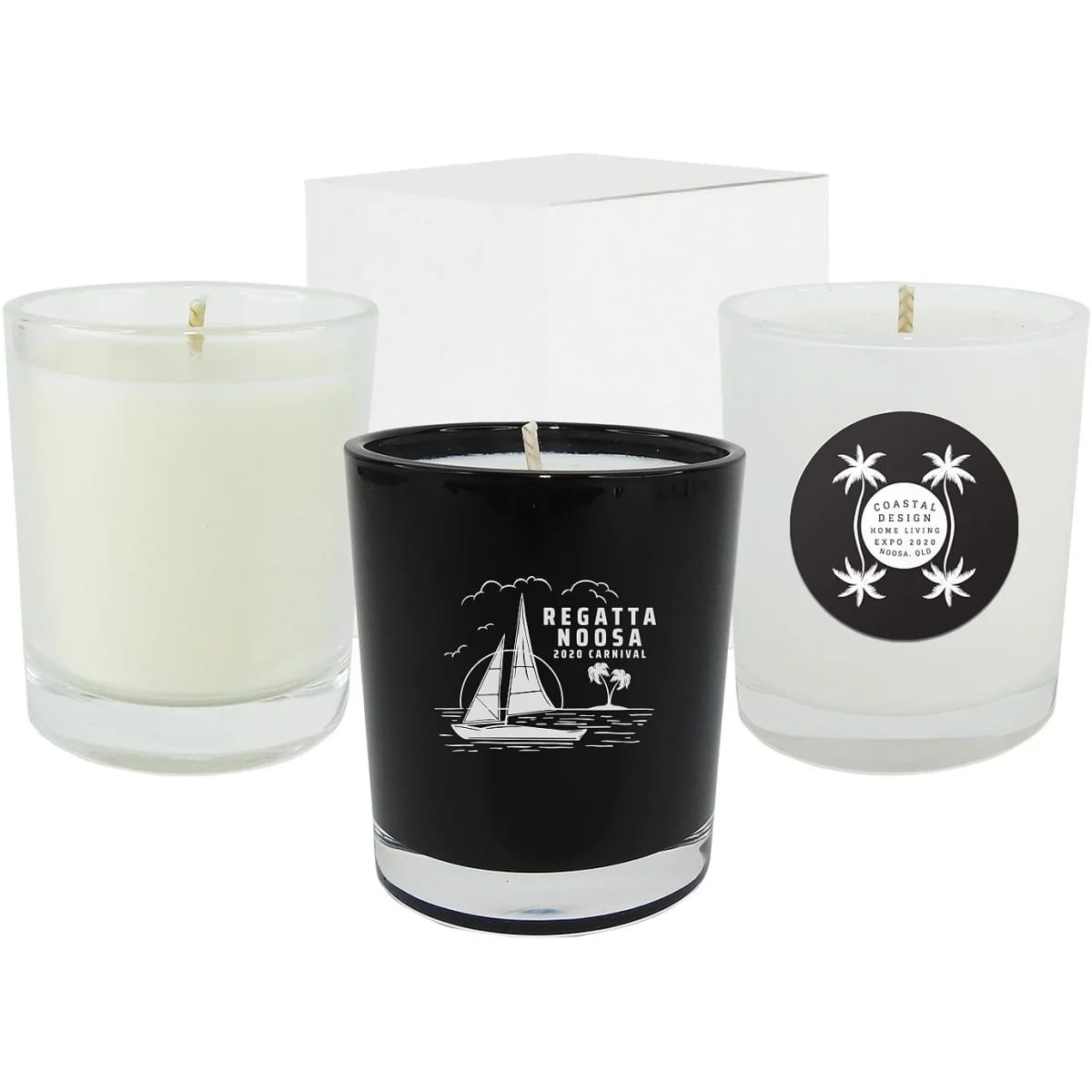 Three glass candles in black and white, featuring different designs, displayed with a white box in the background.