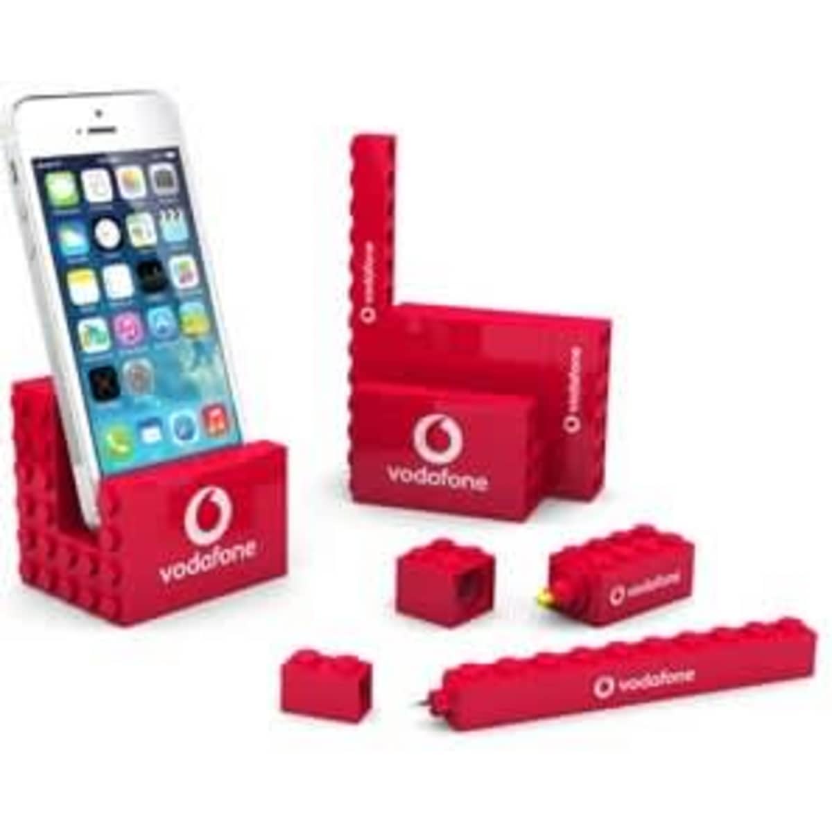 A red stationery set featuring various items including a phone stand, pen, and blocks, all displaying a logo.