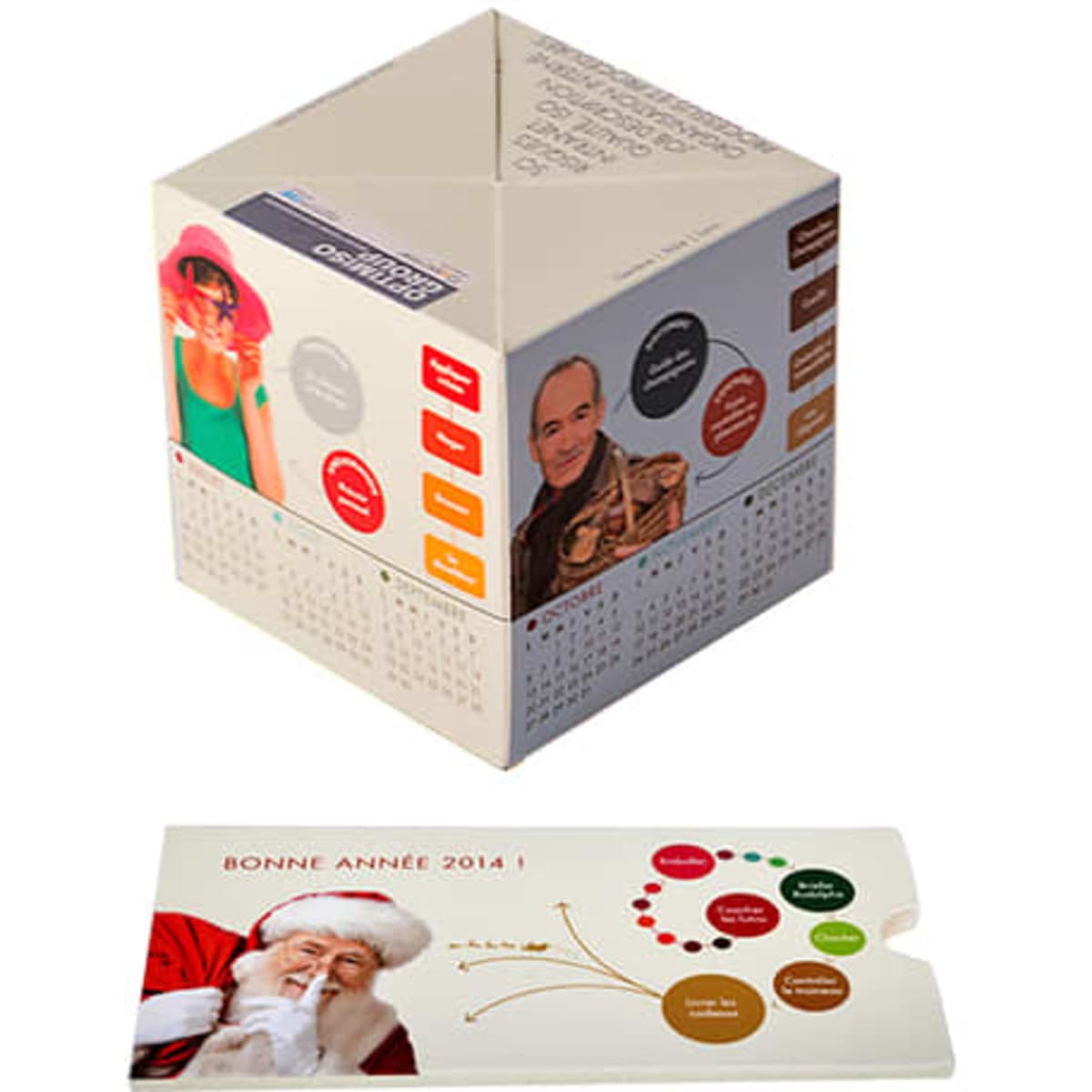 A paper pop-up cube in cream colour featuring various images and a calendar layout, presented with a flat card.