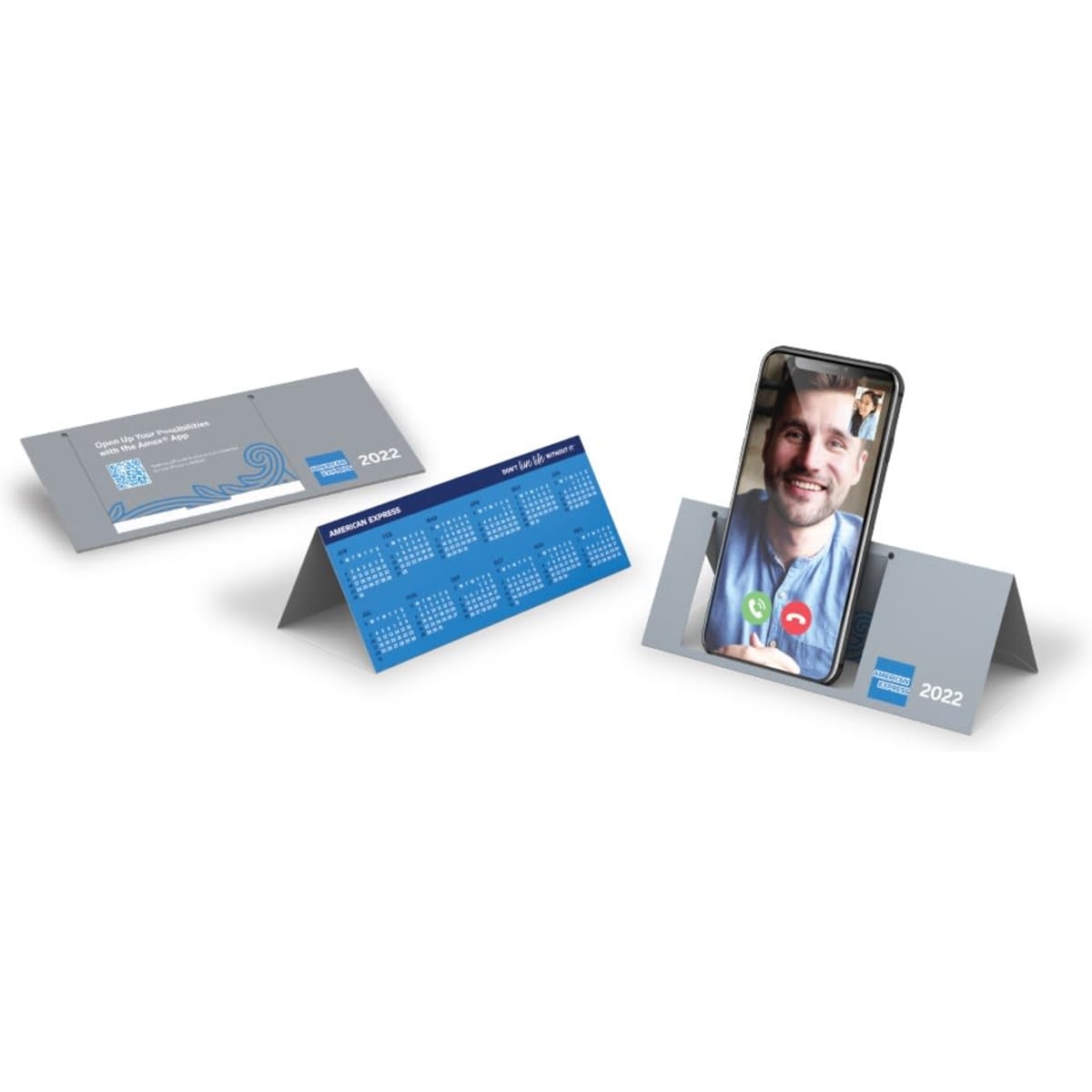 A foldable phone stand in grey, featuring a calendar design on one side and a smartphone propped up on the other.