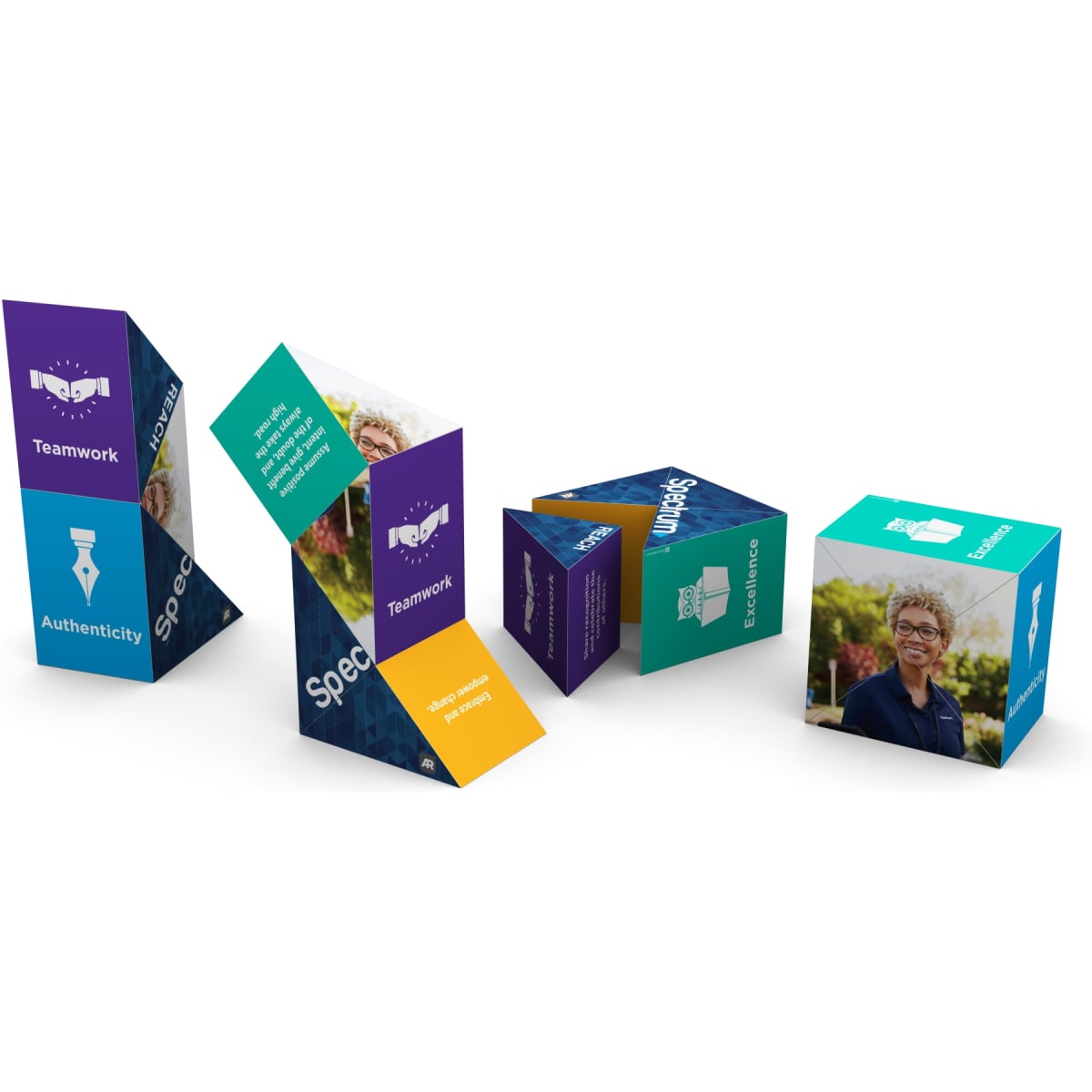 A set of colourful promotional cubes in purple, teal, and orange displaying concepts like teamwork and authenticity.