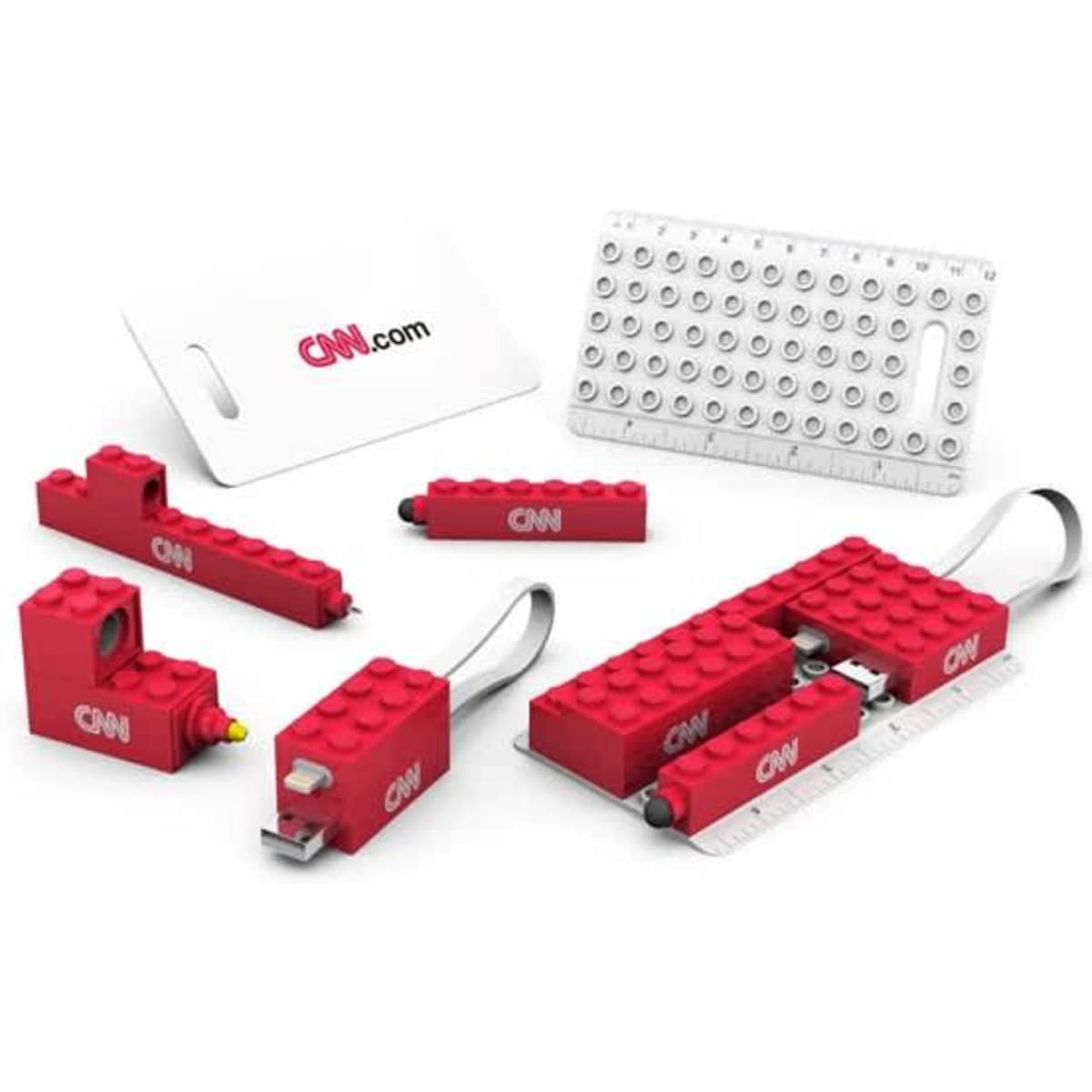 A red travel set featuring various USB sticks, a ruler, and a card, all with a logo.