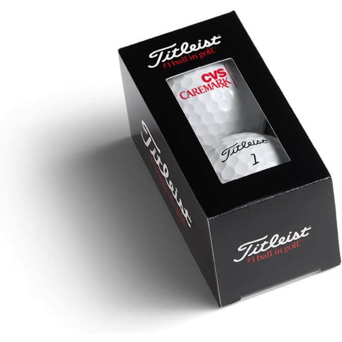 A black and white box containing two golf balls, featuring a logo and the product name.