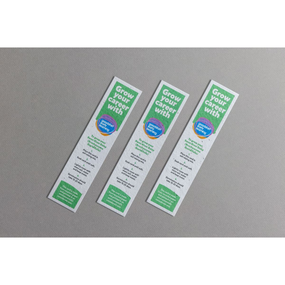 Three large seed paper bookmarks in white with green text and a circular logo, featuring a textured, eco-friendly design.