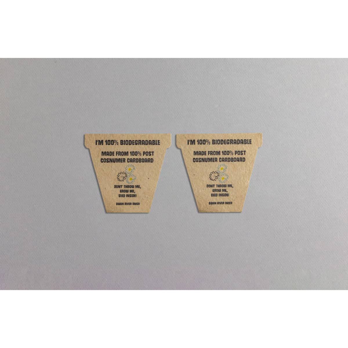 Two biodegradable seed paper flower pot labels made from 100% post-consumer cardboard, featuring a natural brown colour.