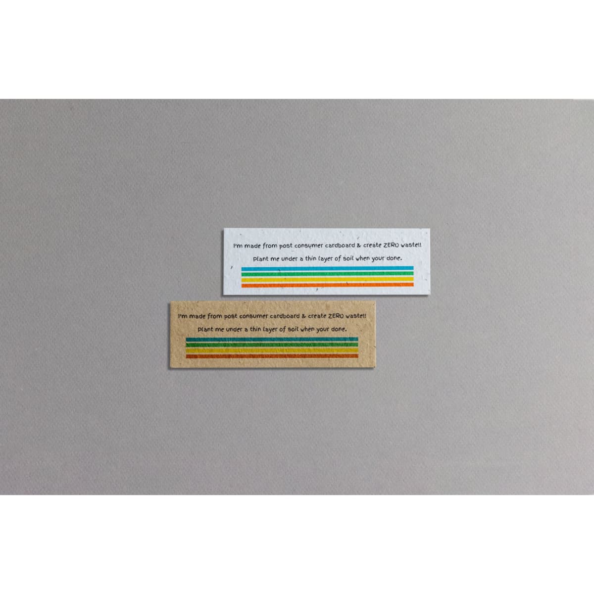 Two seed paper bookmarks in natural and brown shades, featuring vibrant stripes and branding.