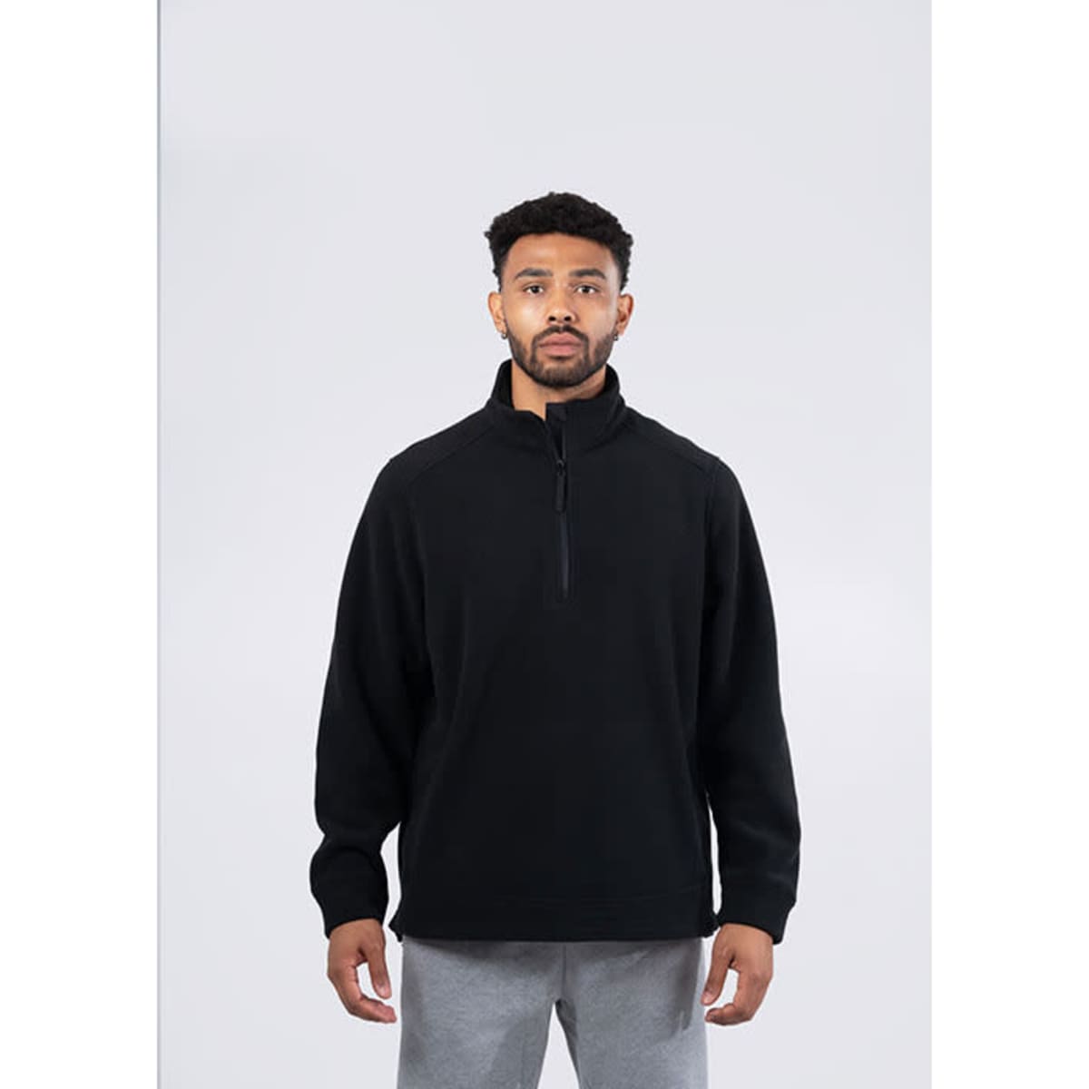A black polar fleece half zip top with long sleeves and side pockets, featuring a branding logo.